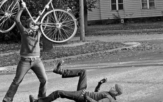 Cyclist attacking man with a bike