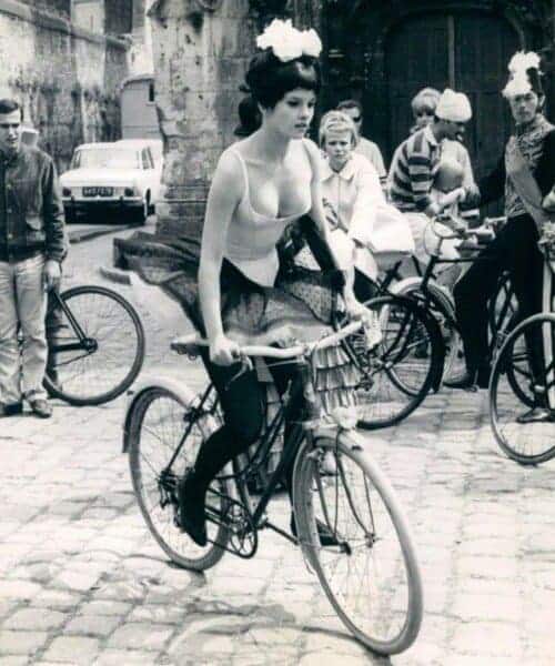 Woman riding vintage bike with other cyclist in the background