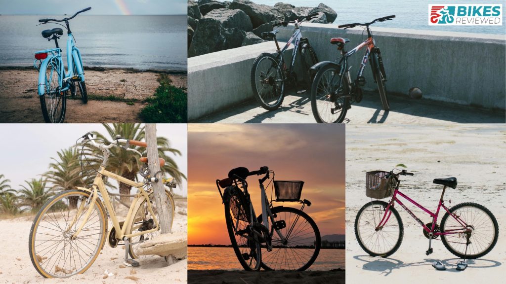 Collage of five bikes by the beach. Top left: blue bike with a rainbow over the ocean. Top right: two bikes by a seawall and rocks. Bottom left: yellow bike with palm trees. Bottom center: bike with a basket at sunset. Bottom right: pink bike with a basket on sandy beach next to flip-flops. "Bikes Reviewed" logo in top right corner.